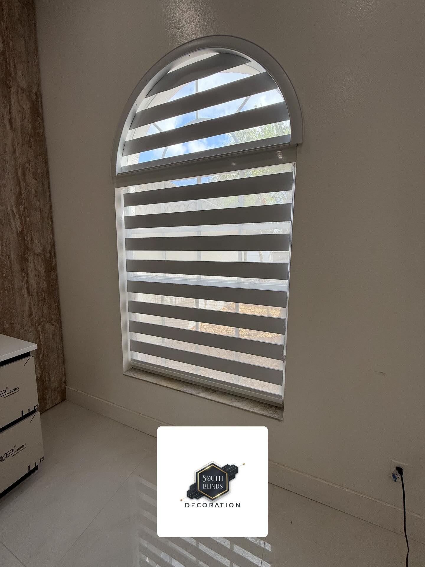 Custom arched zebra blinds installation in Miami home